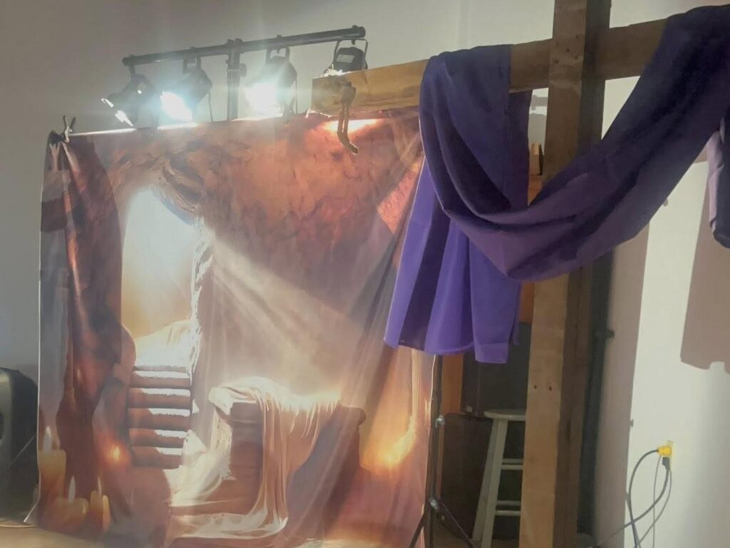 Tapestry of the empty tomb next to the cross from Porterville First Assembly of God Easter service